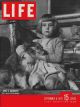 Life Magazine, September 8, 1947 - Little English girl hugging Dog
