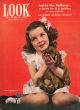 Look Magazine, June 15, 1943 - Charming little girl holding her dog